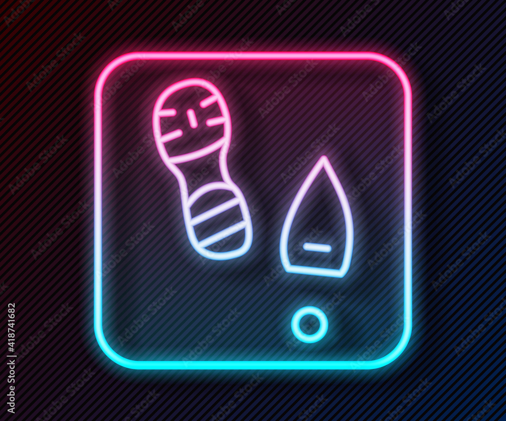 Glowing neon line Human footprints shoes icon isolated on black background. Shoes sole. Vector.