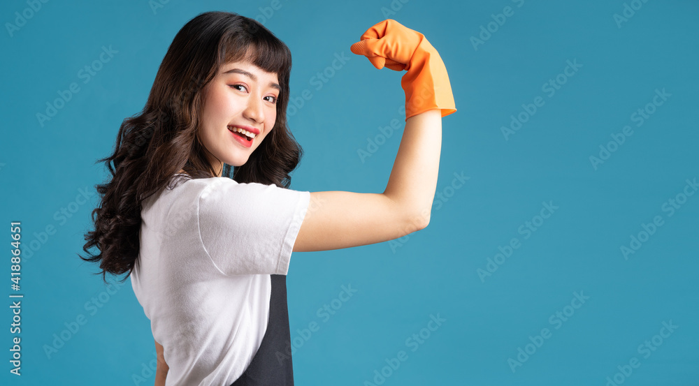 A photo of an Asian woman in an apron and gloves preparing for the cleaning job