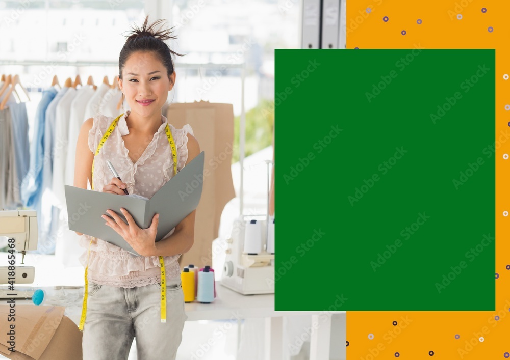 Portrait of smiling asian female fashion designer at work with yellow and green copy space on right