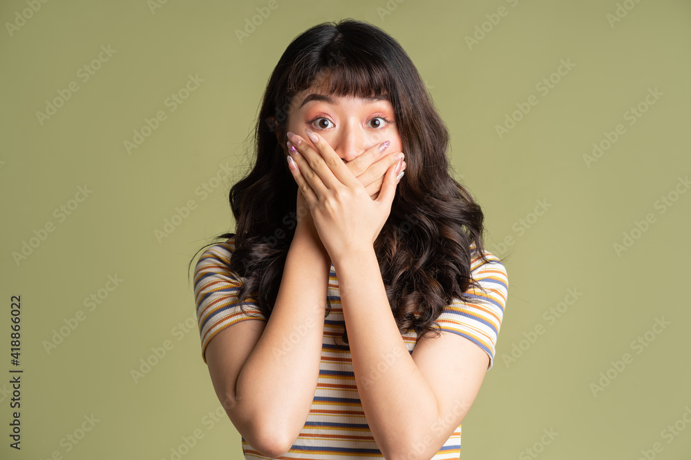 Young beautiful Asian woman posing on background