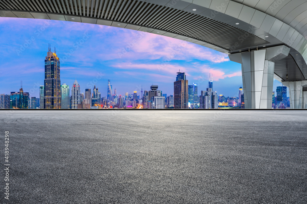 Race track road and bridge with city skyline at night in Shanghai.