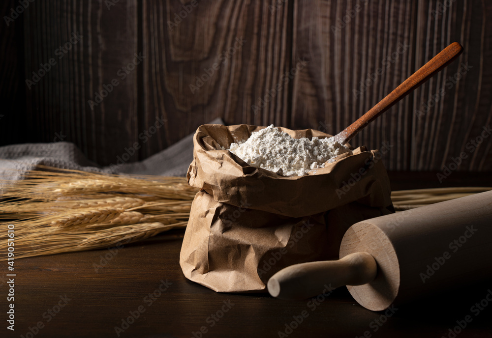 Flour set against a dark wooden background