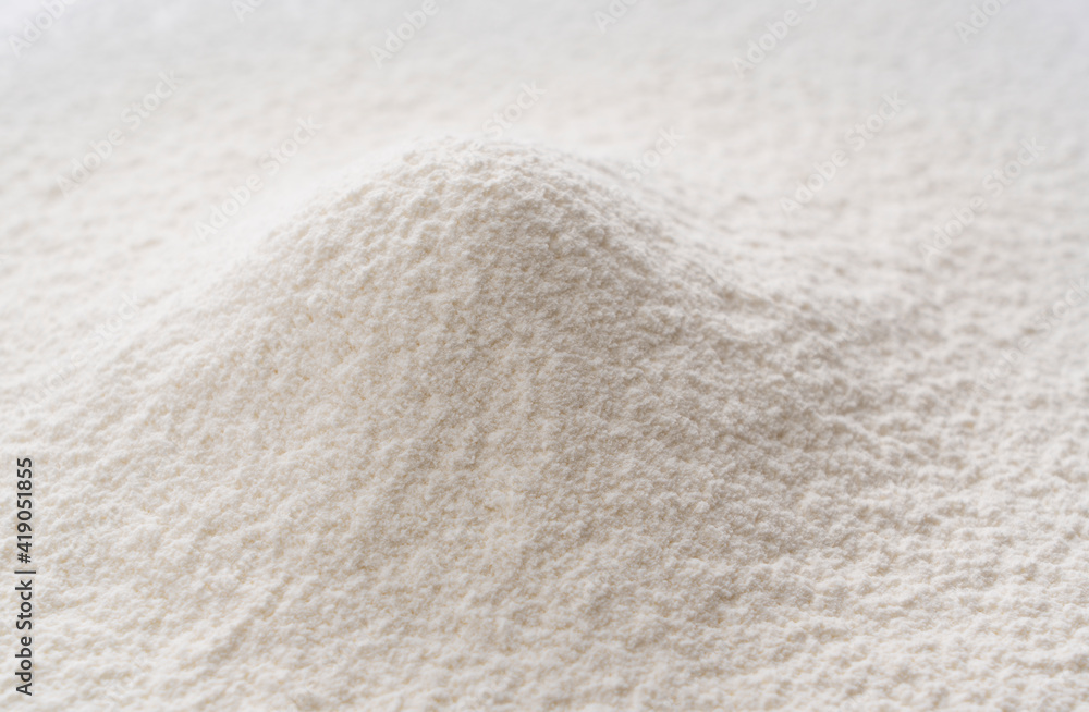 Close-up of a pile of flour being sifted.