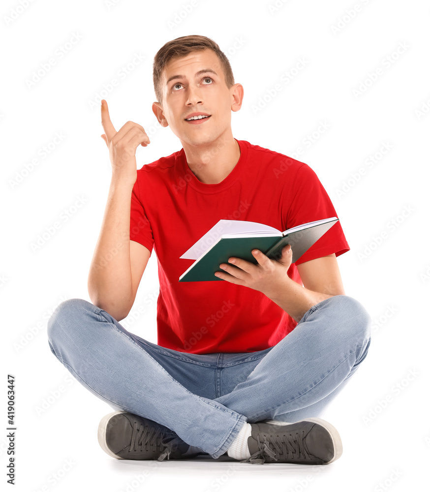 Happy young man with book on white background