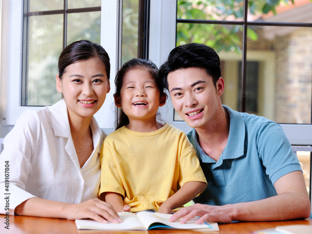 Happy family of three reading together