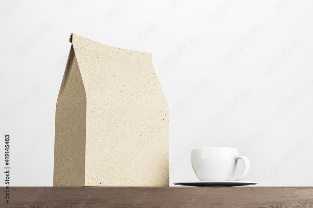 Recycled kraft coffee package with copyspace for your logo with white cup on wooden surface at white