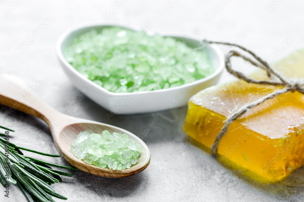 natural bath salt with rosemary on stone table background