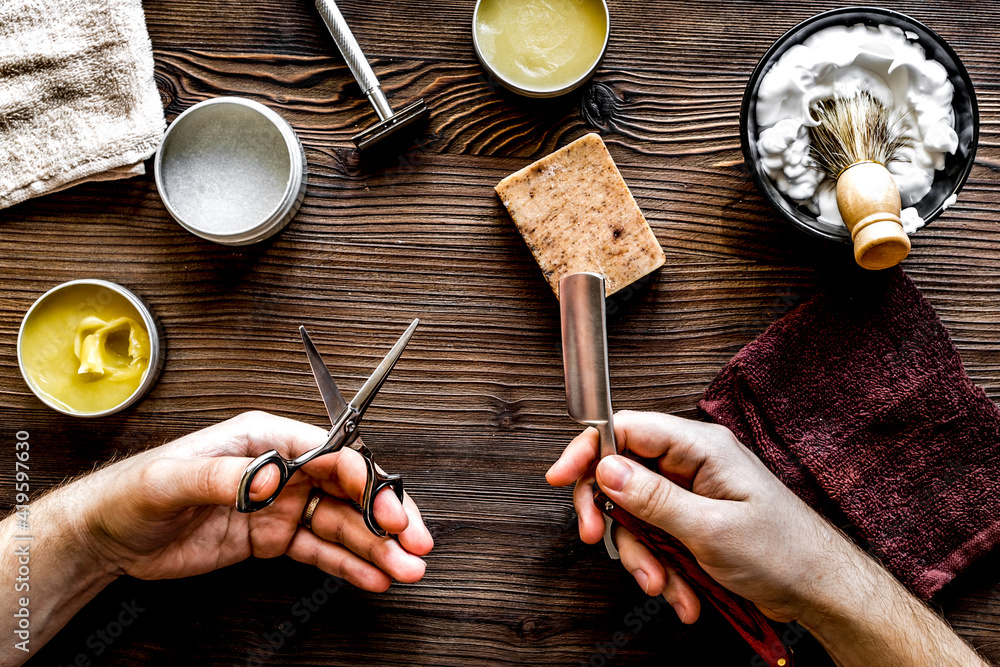 Tools for cutting beard in barbershop on workplace background top view