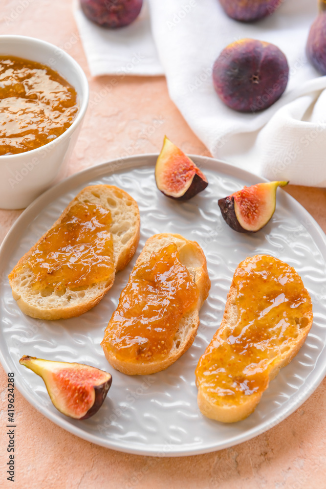 Toasts with sweet fig jam on color background