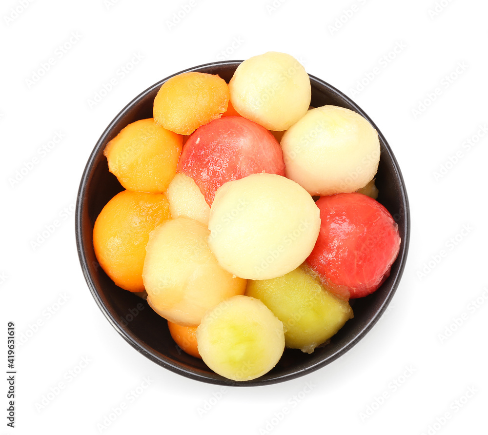 Bowl with sweet fruit balls on white background