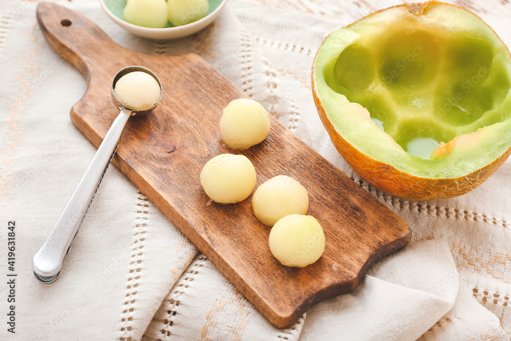 Composition with sweet melon balls on wooden background