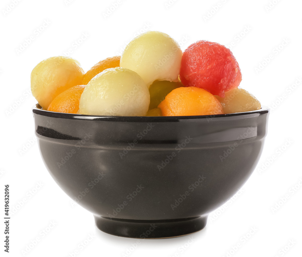 Bowl with sweet fruit balls on white background