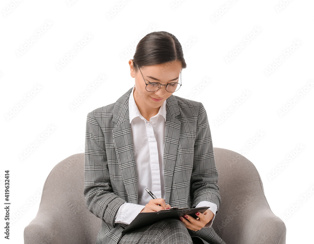 Portrait of female psychologist sitting in armchair on white background