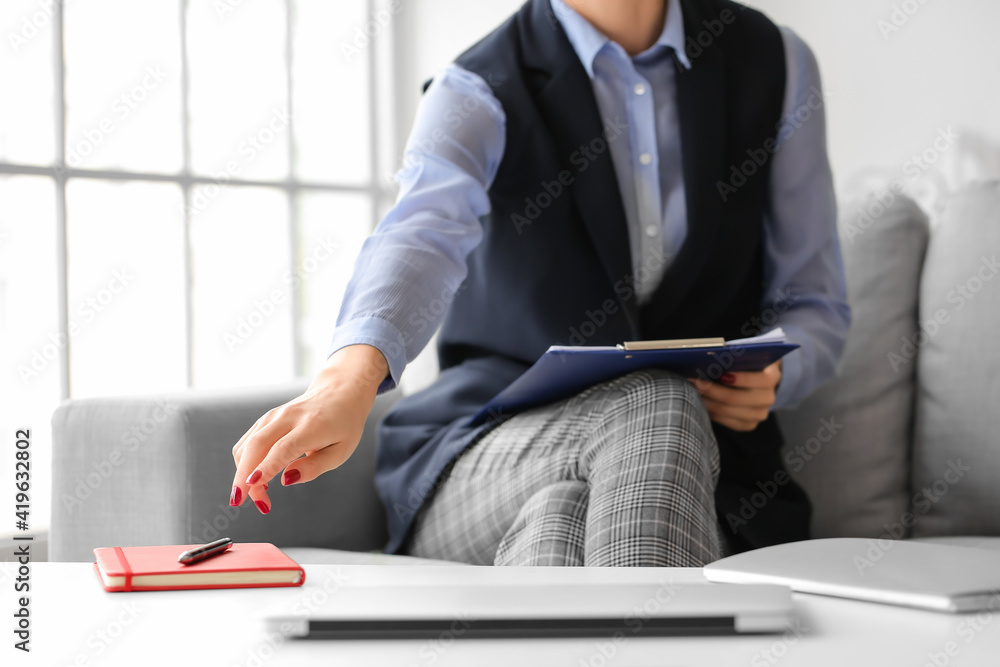 Female psychologist sitting on sofa in office