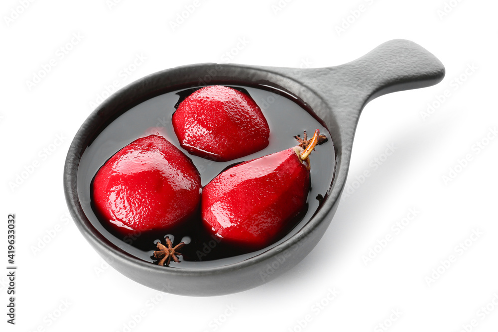 Baking dish of tasty poached pears in wine sauce on white background