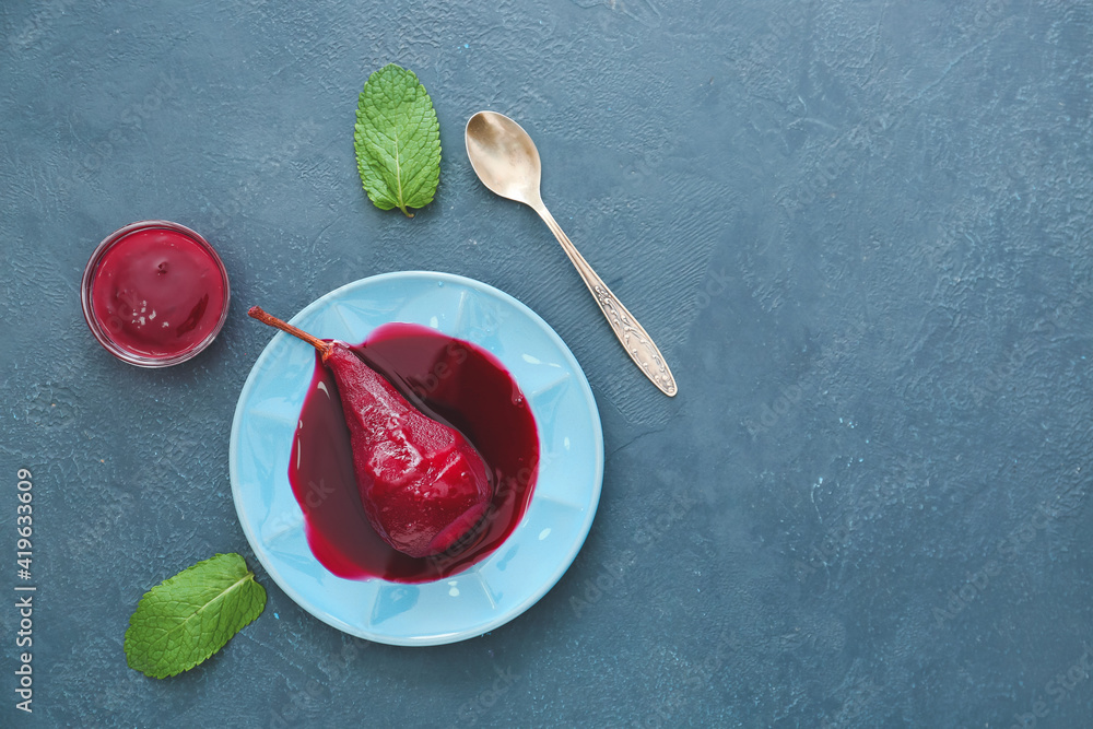 Plate of tasty poached pears in wine sauce on color background