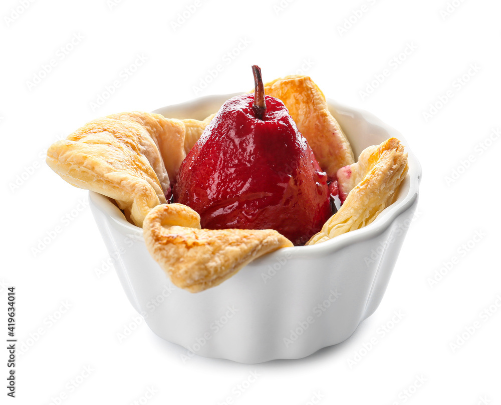 Baking dish of tasty poached pears in wine sauce on white background