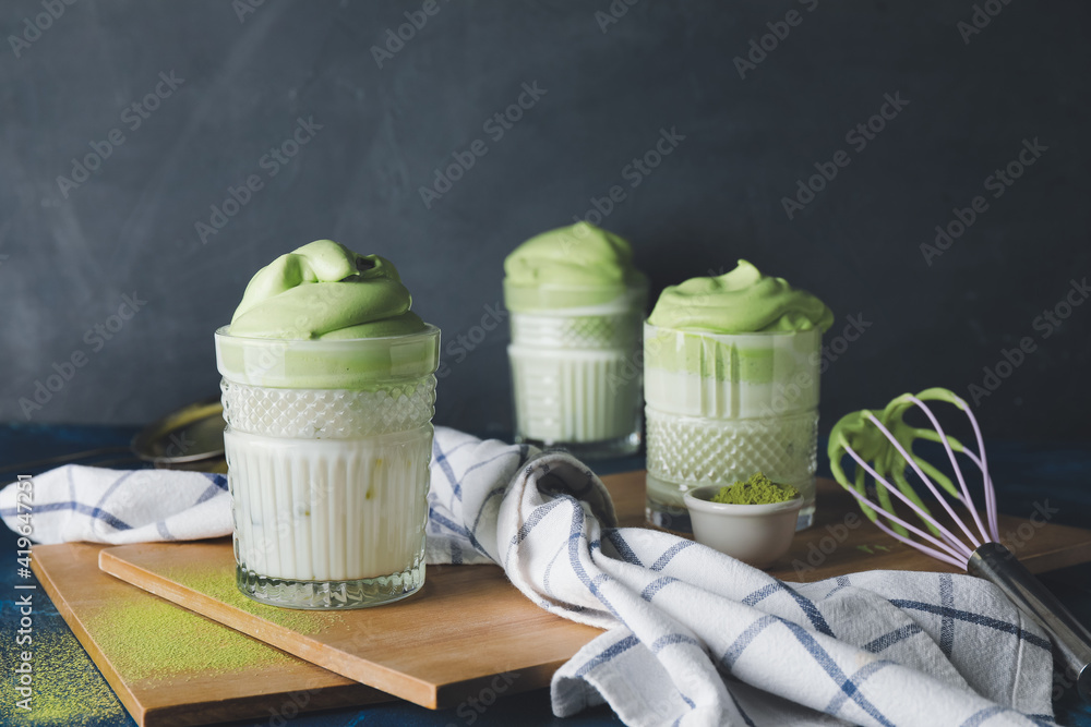 Composition with tasty dalgona matcha latte on dark background