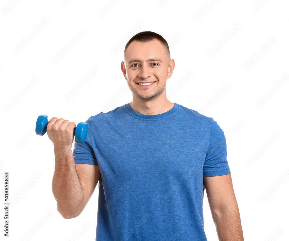 Handsome young man training with dumbbell on white background