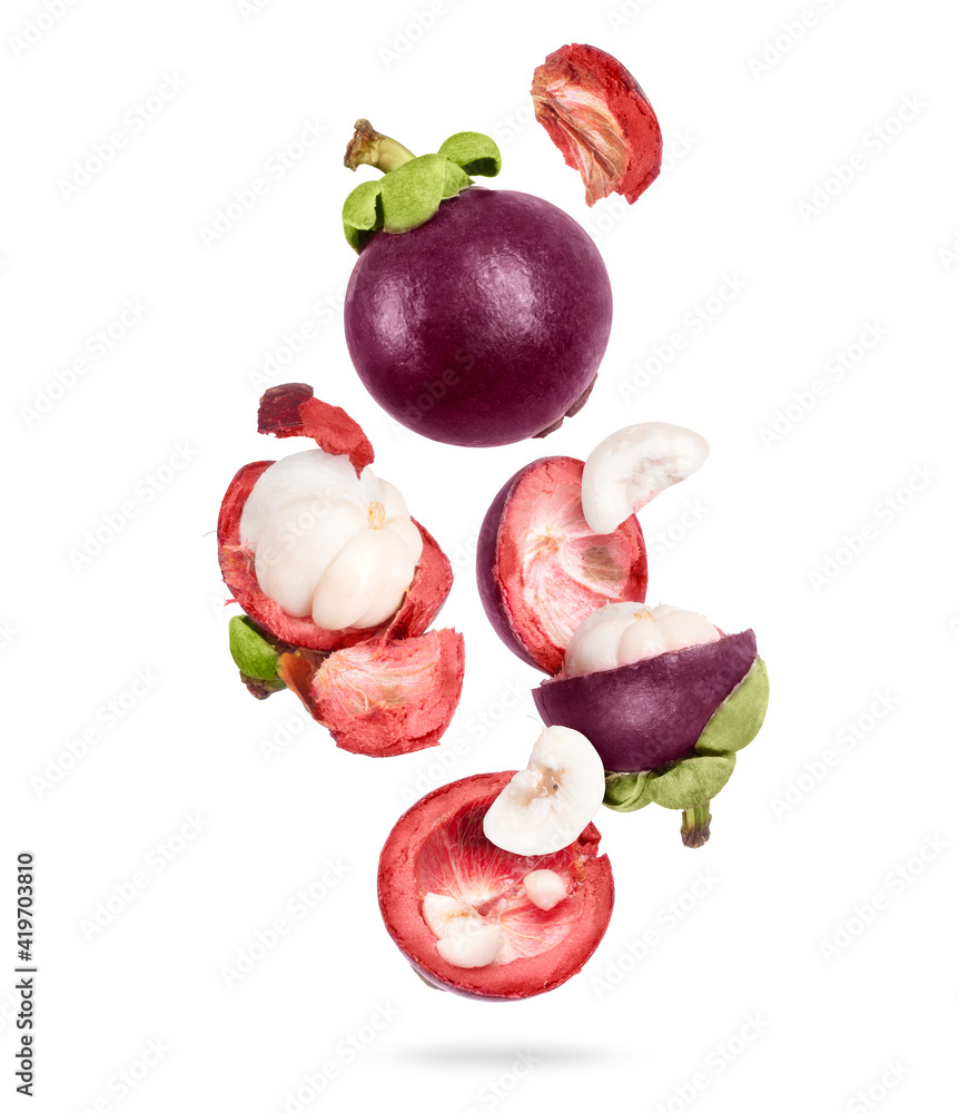 Whole and sliced ripe mangosteen in the air, isolated on a white background