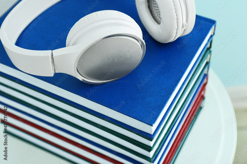 Stack of books and headphones on stool, closeup