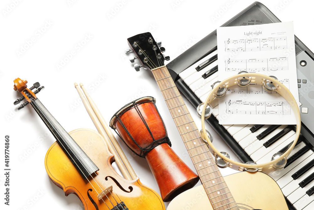 Different musical instruments and music notes on white background