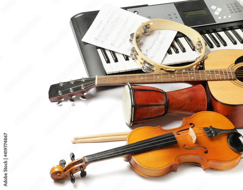 Different musical instruments and music notes on white background