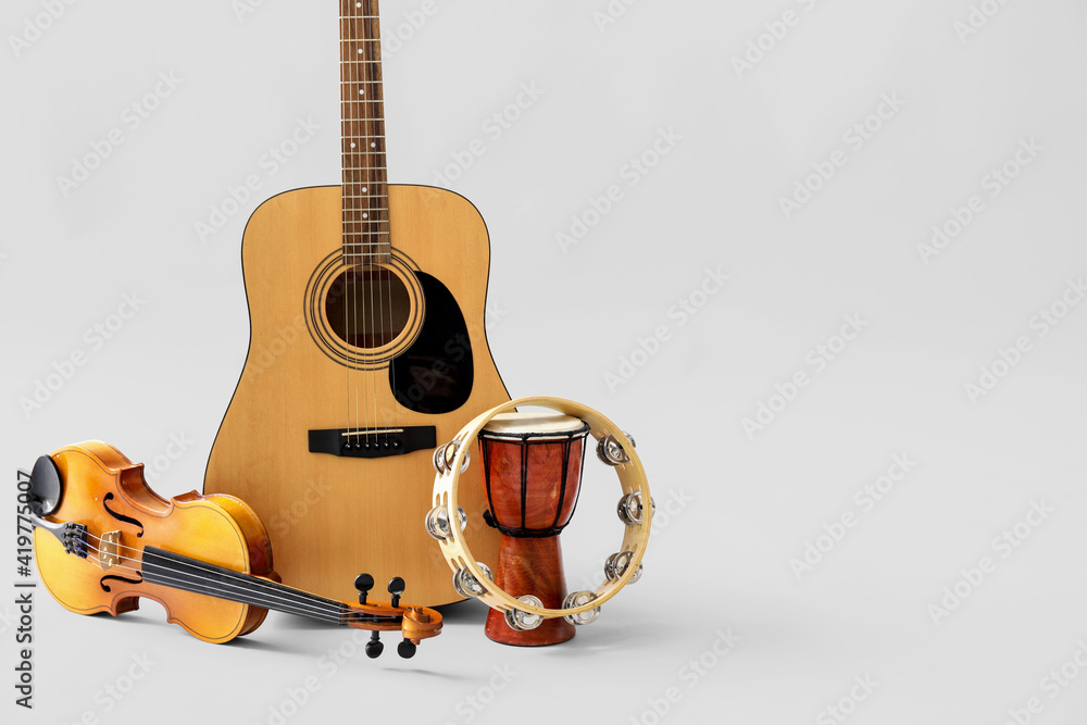 Different musical instruments on light background