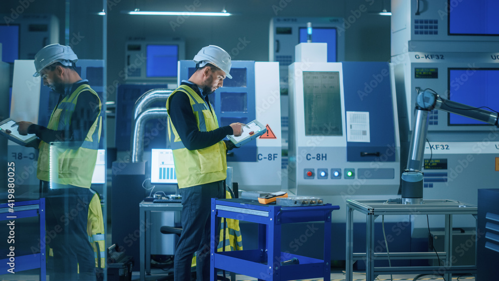 Modern Factory: Professional Engineer Wearing Safety Vest and Hardhat, Uses Industrial Digital Table