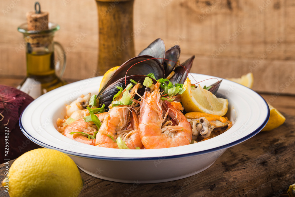 Tasty Spanish paella with seafood .