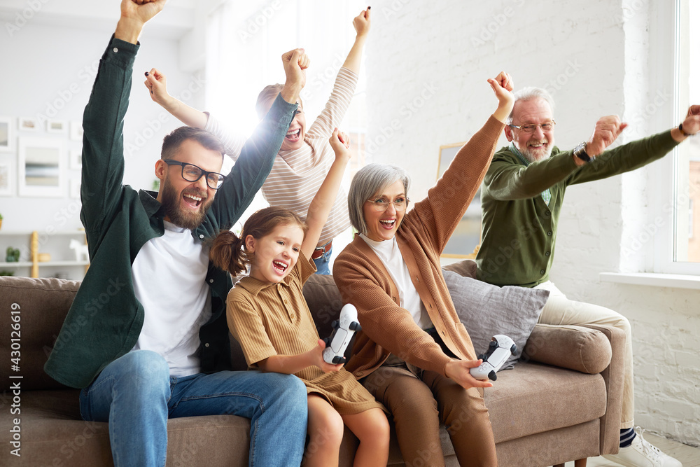 Big happy multi generation family playing video games at home