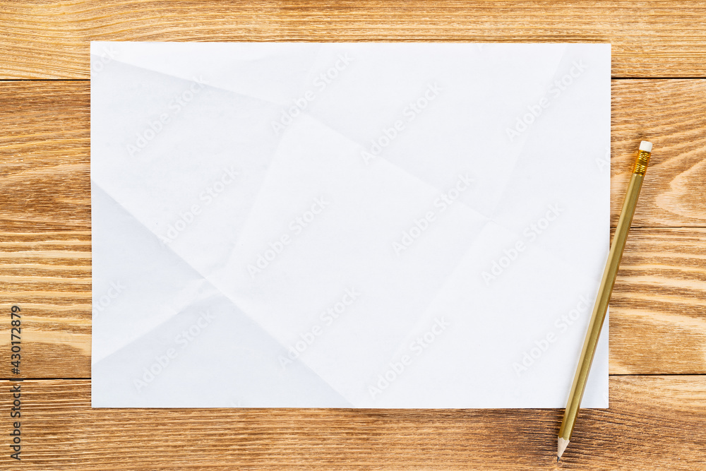 Sheet of paper lying on wooden table