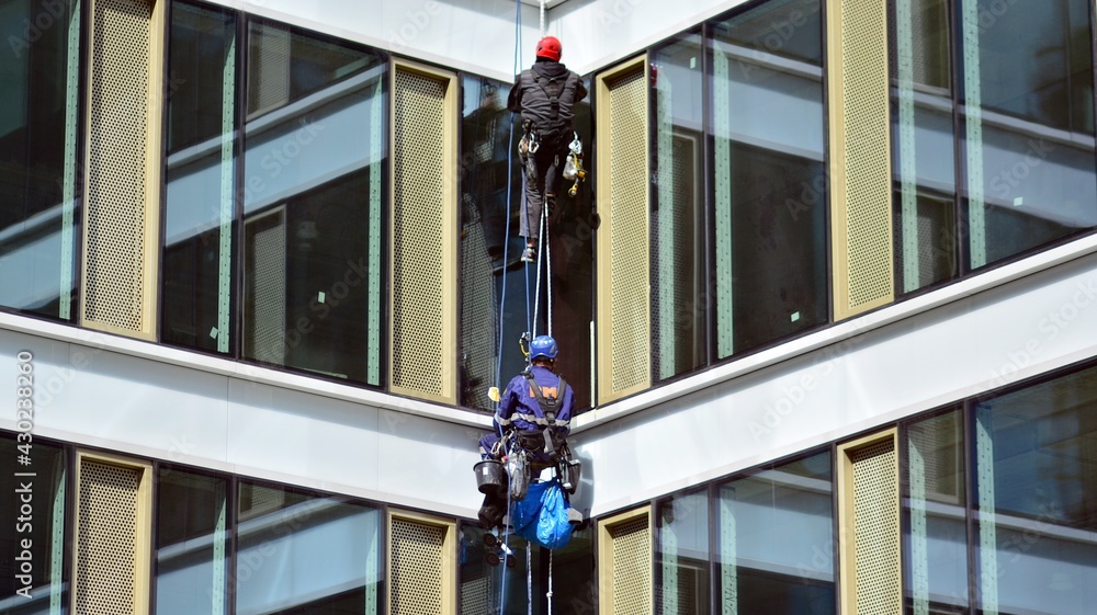 Two specialist technicians check and repair the facade of the building