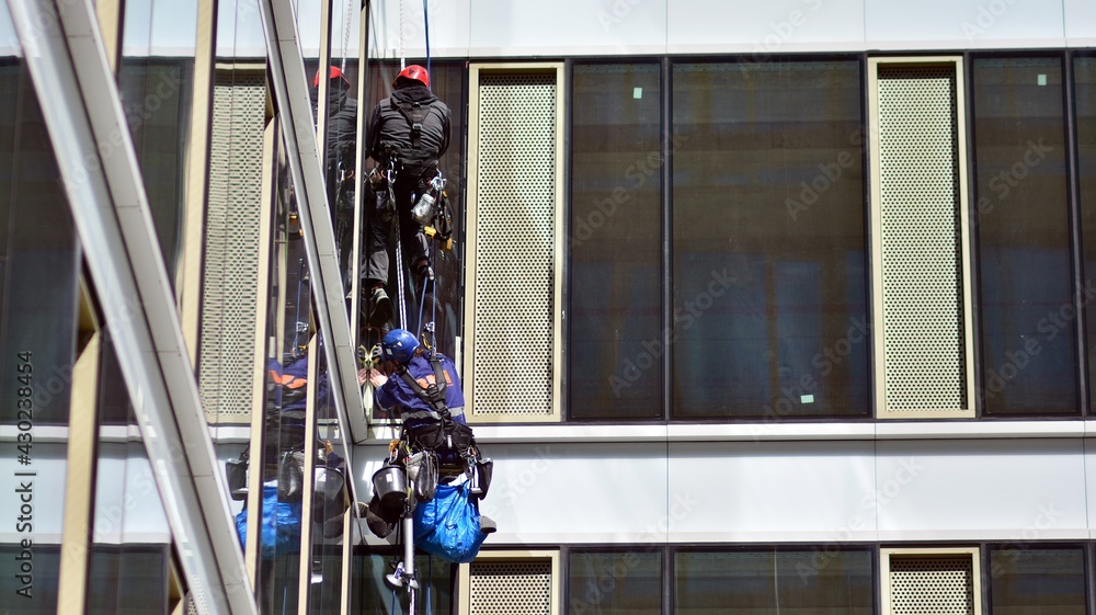 Two specialist technicians check and repair the facade of the building