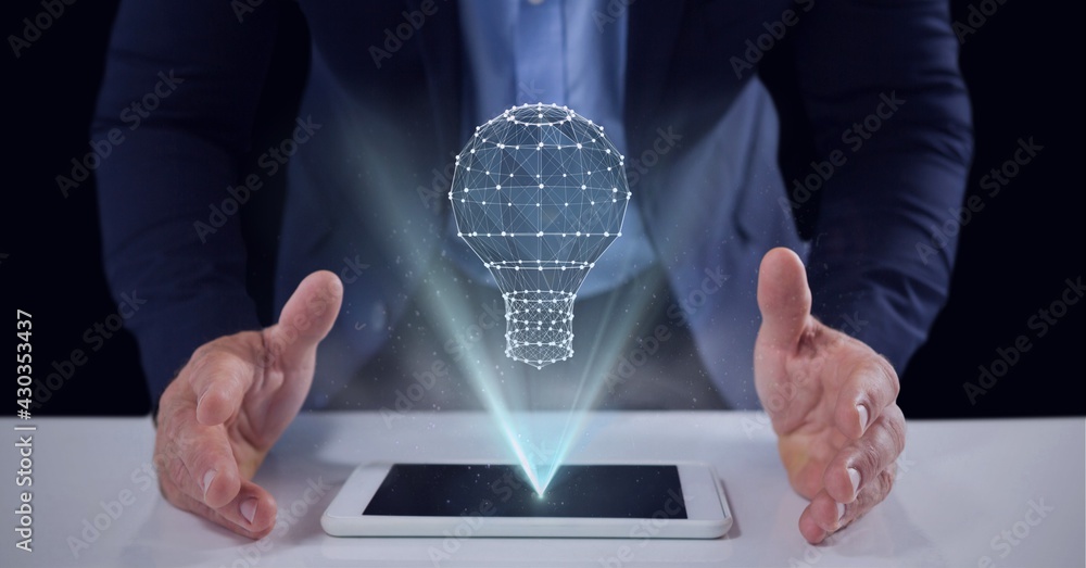 Composition of businessman holding hands over light bulb with network of connections and tablet