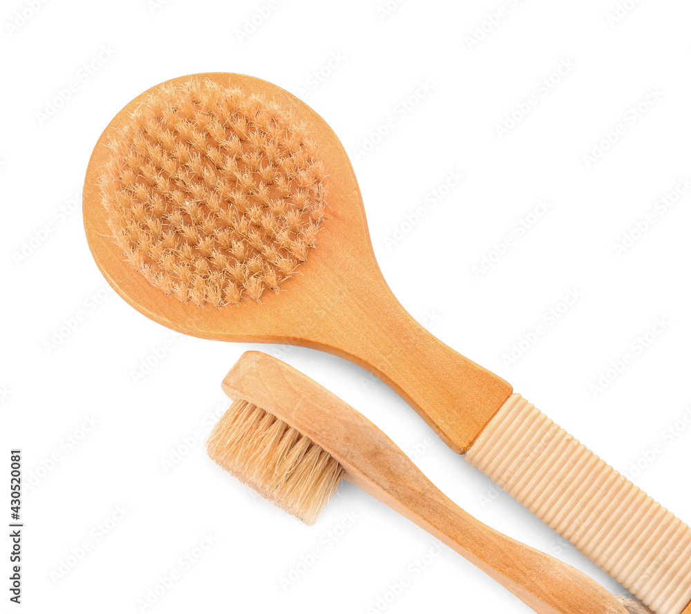 Different massage brushes on white background