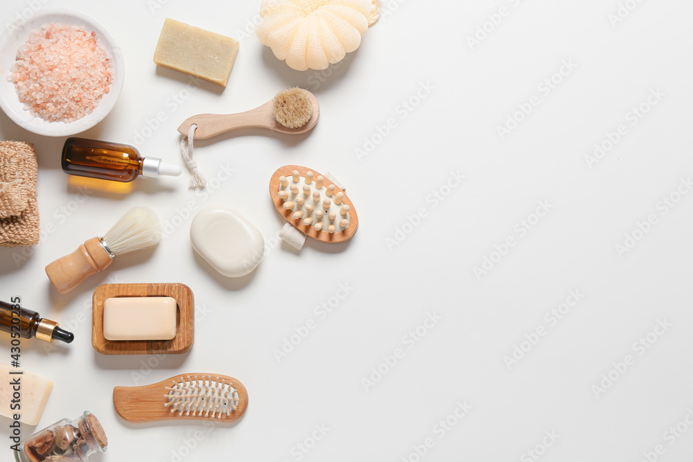 Composition with massage brushes and bath supplies on white background