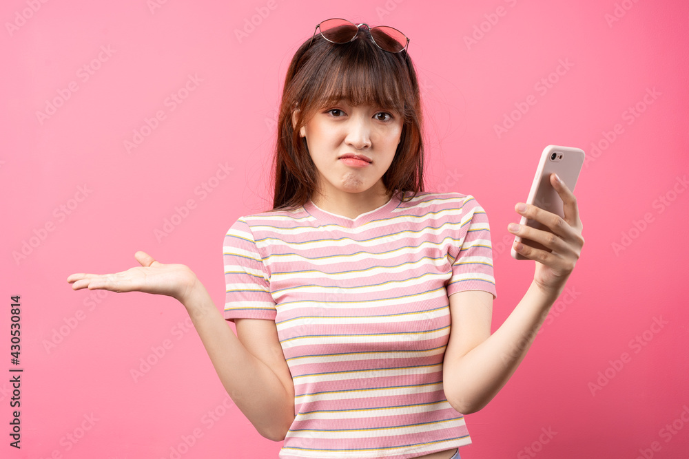 Image of young Asian girl wearing pink t-shirt on pink background