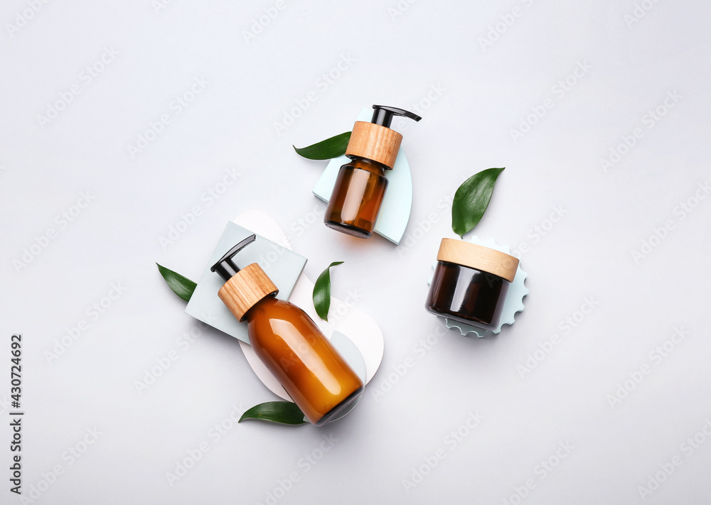 Bottles of cosmetics for hair on white background