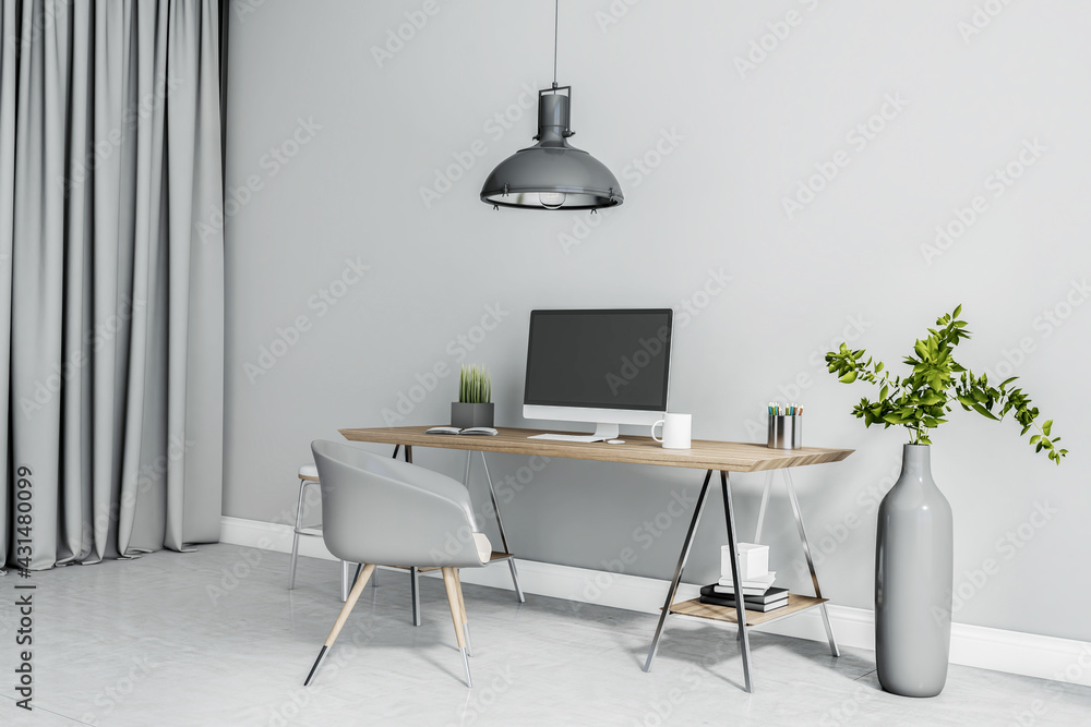 Modern design workspace in grey shades with computer monitor on wooden table, chair and long vase on