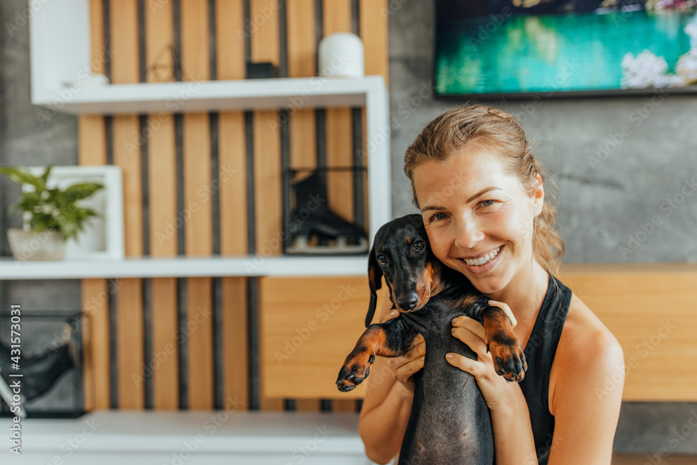 Smiling face, woman holding her dog.