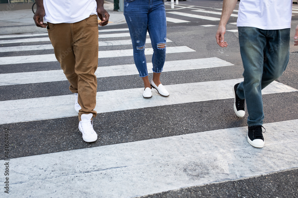 Streetwear apparel jeans men and women crossing road in city