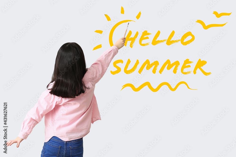 Cute little artist writing text HELLO SUMMER on light background