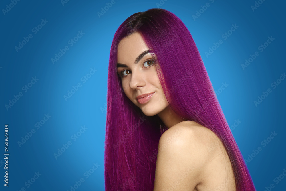 Beautiful young woman with unusual hair on color background