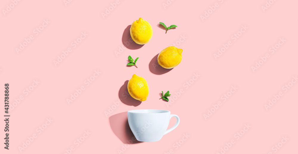 Fresh yellow lemons with tea cup overhead view