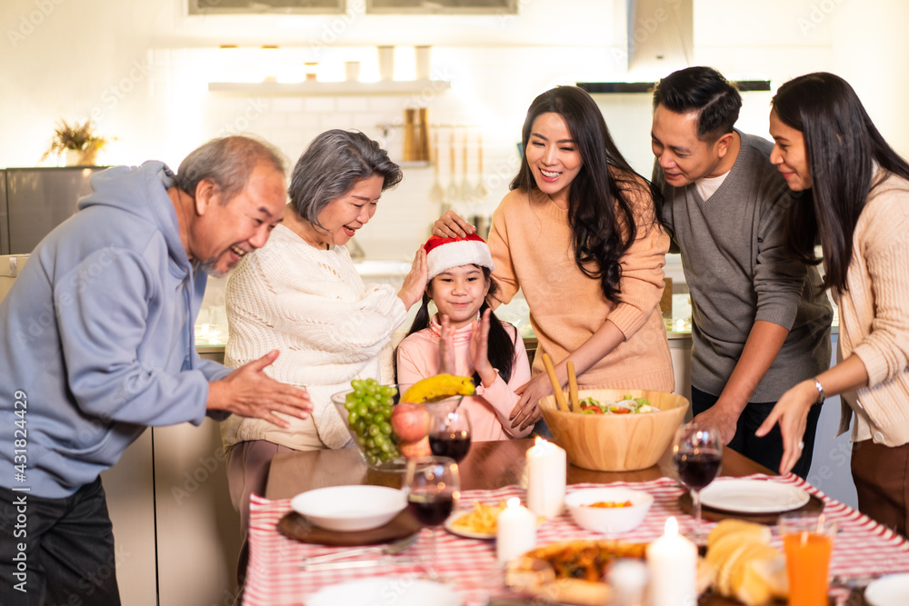 Asian big family sing a song while preparing foods for Christmas party