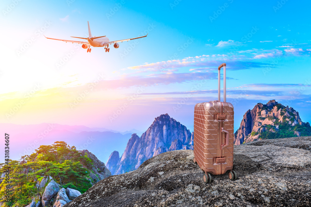 Travel suitcase on top of the mountain at sunrise.Travel concept.