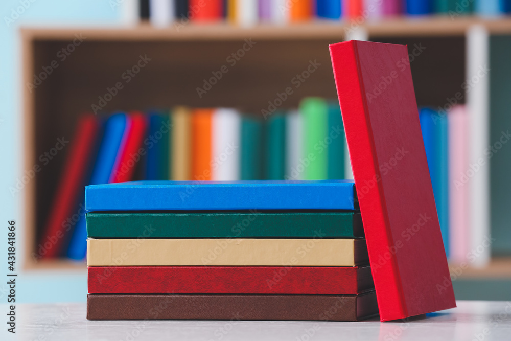 Stack of books on table in library