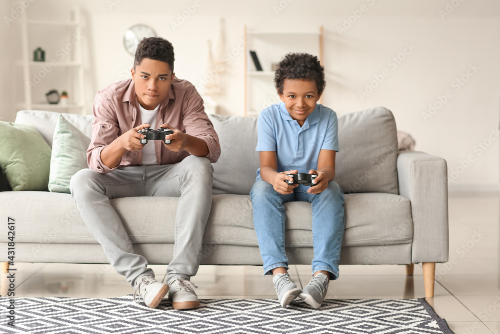 African-American boys playing video game at home