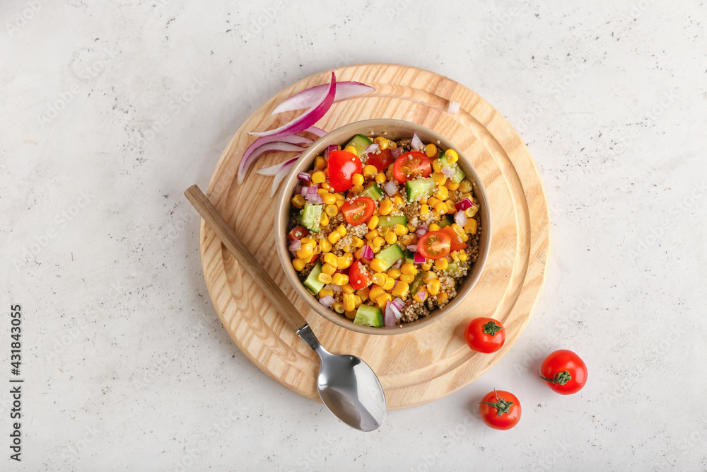 Composition with tasty quinoa salad on light background